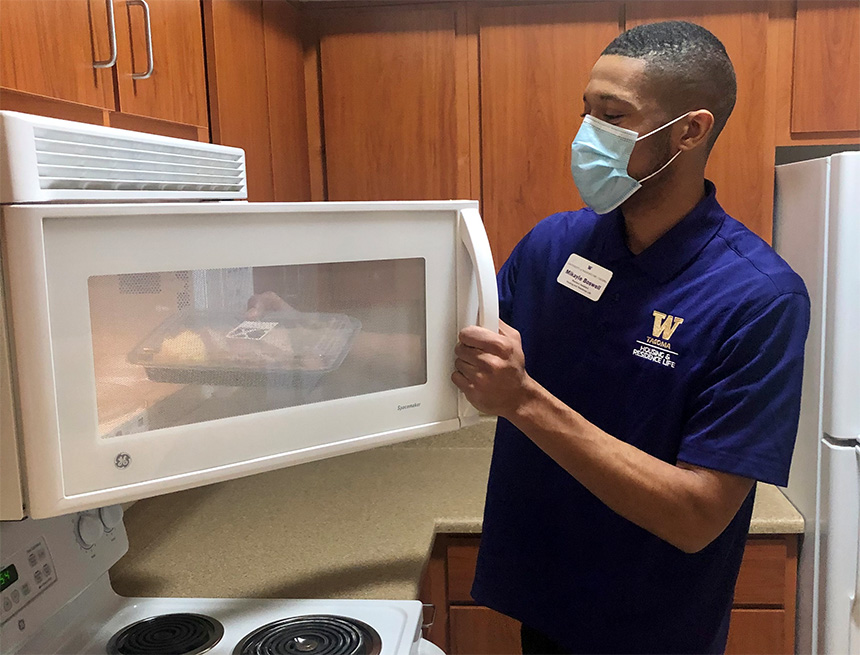 Mikayle Boswell, RA and senior in communications, is in the kitchen of a Court 17 apartment.