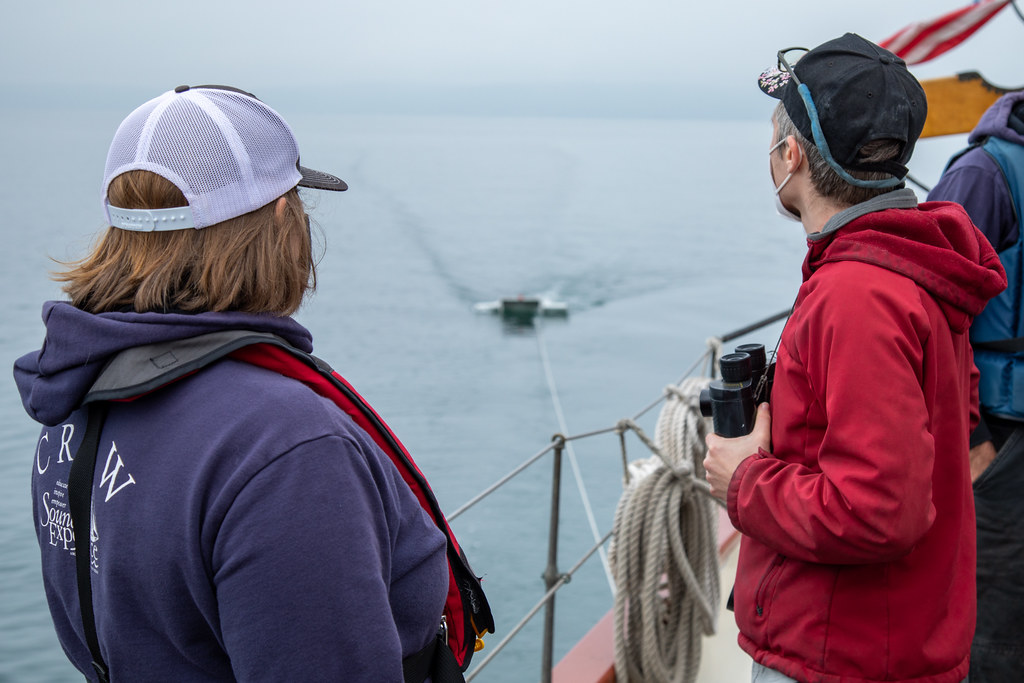 Julie Masura and Morgan Heinz watch manta trawl being towed from Adventuress