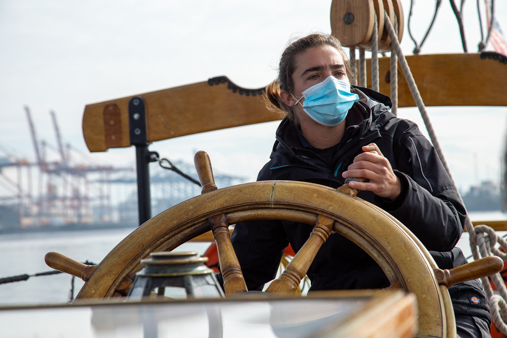 Adventuress Captain Katelinn Shaw at the helm on Commencement Bay