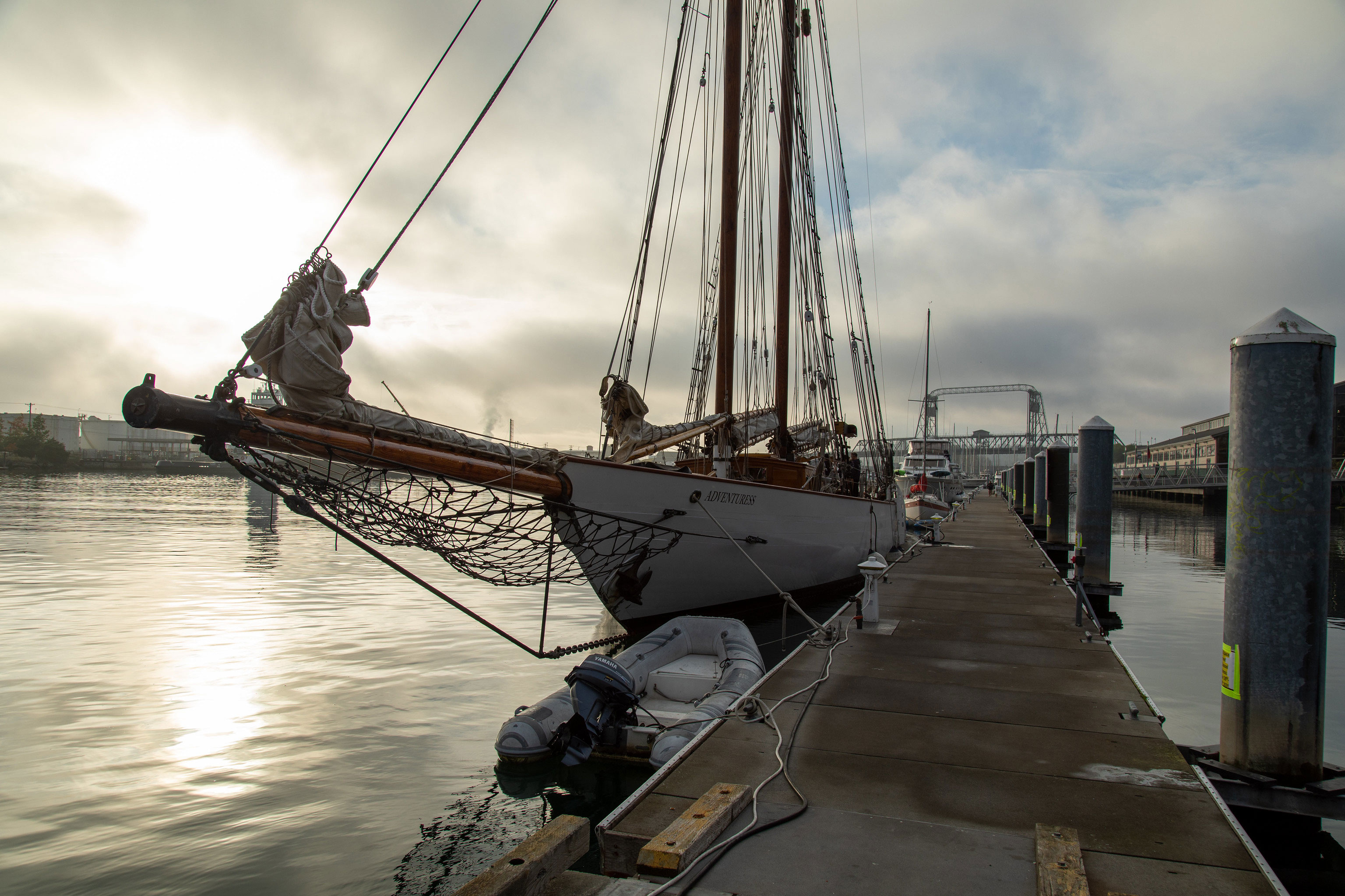 SS Adventuress at dock, sun rising, overcast sky with sunbreaks