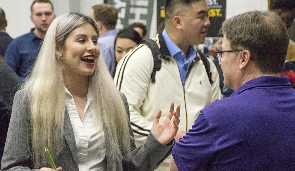 Photo of people speaking at a career fair