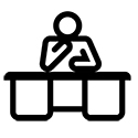 Person sitting behind office desk icon