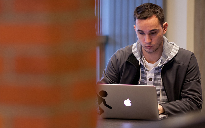 Student at UW Tacoma working on laptop