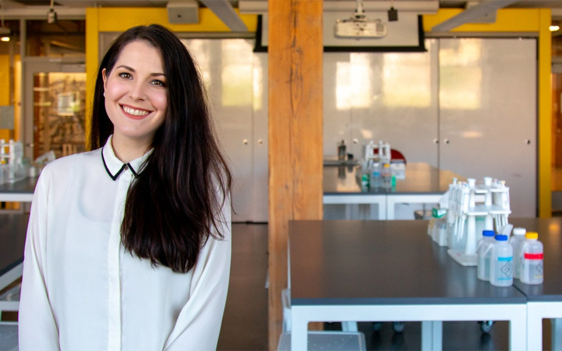 UW Tacoma alumna Emily Swanson, posing in campus research lab