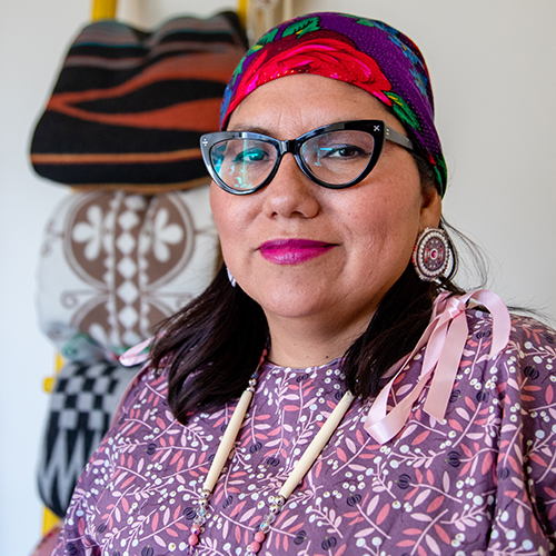 Headshot of UW Tacoma Ed.D. Director Robin Minthorn. Minthorn is wearing glasses, a multi-colored head wrap and a floral print dress.