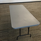Rectangular table with black metal legs and gray plastic top