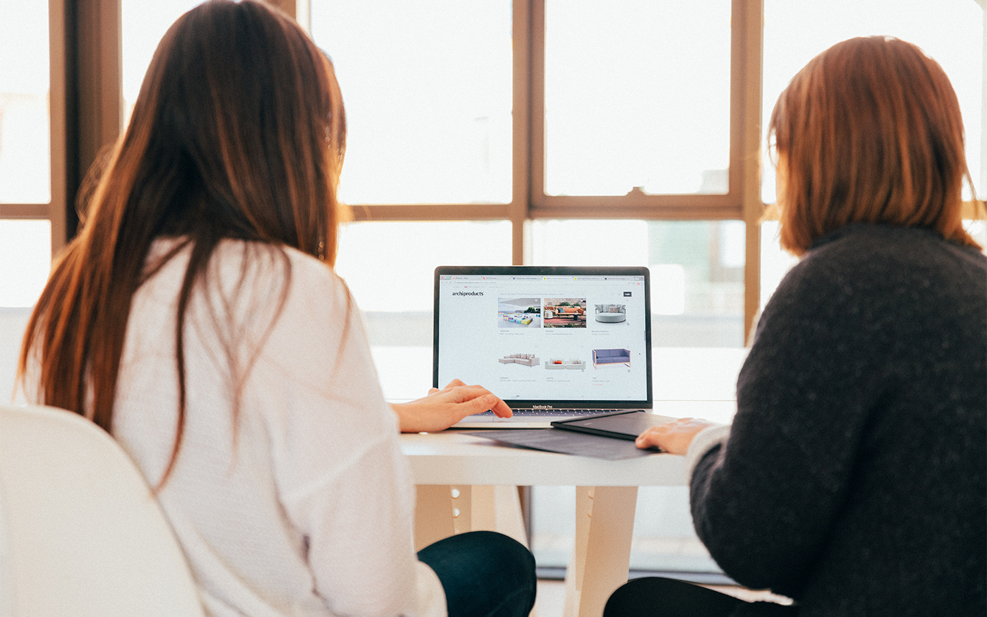 Two women looking at a laptop computer