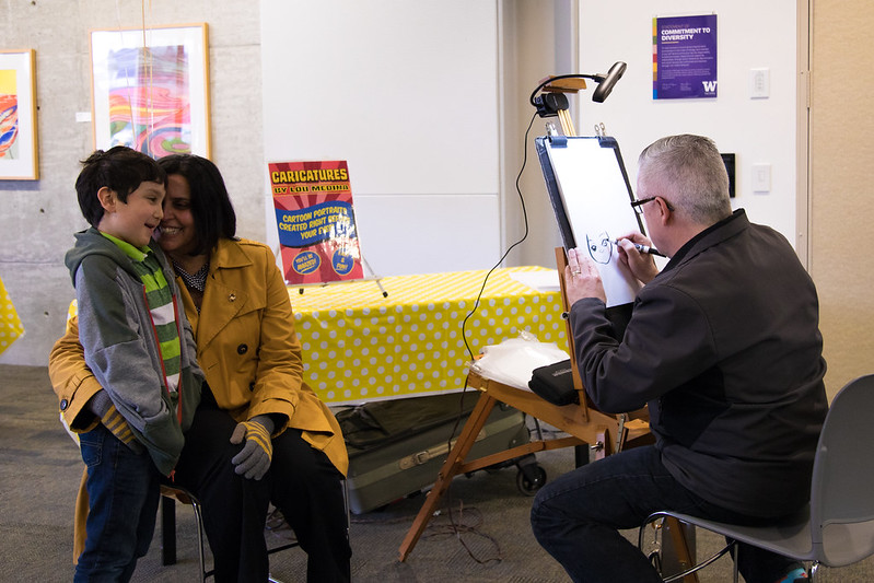 Photo of caricature being drawn of mother and son