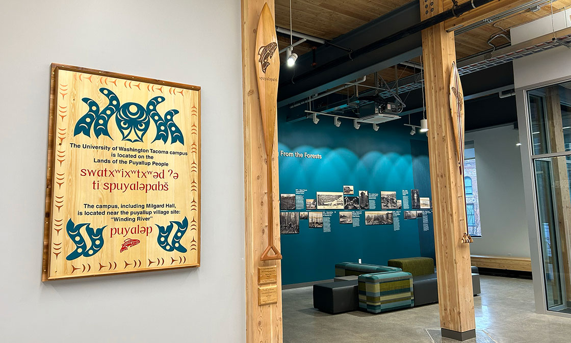 The land acknowledgement, paddles and history display in Milgard Hall