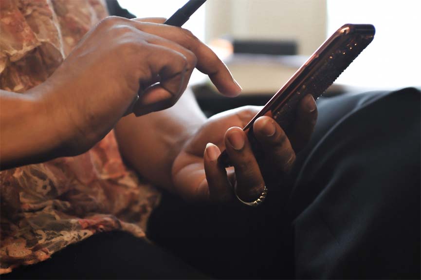 Hands holding and swiping a smartphone