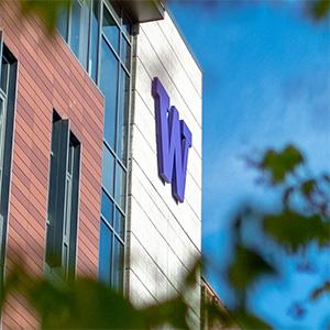 W on Tioga Library Building seen through trees