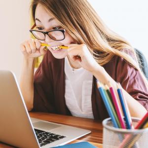 Lady biting pencil