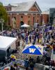 2021 Convocation at UW Tacoma - tents in foreground, crowds of attendees, Snoqualmie Power House in background.