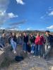 Students smiling while sitting on top of large rocks