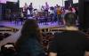 Two women look on as the cast of Rock of Ages takes the stage