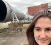 UW Tacoma mechanical engineering student Amy Keller at NASA Langley Research Center standing in front of the exit nozzle of the high-temperature wind tunnel.