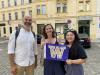 Three people holding up the UW flag